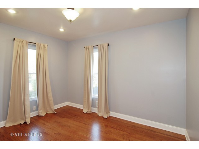 238 Lionel Road Riverside, IL 60546 - Photo 19 of 24 an empty room with wooden floor and a window
