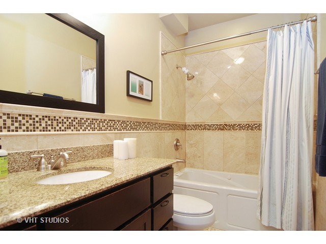 238 Lionel Road Riverside, IL 60546 - Photo 20 of 24 a bathroom with a granite countertop sink a mirror and a shower