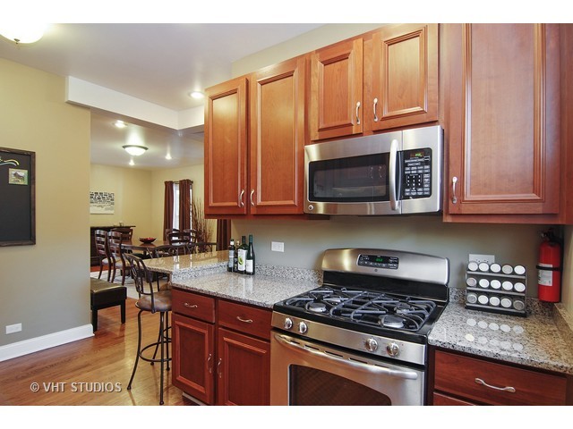 238 Lionel Road Riverside, IL 60546 - Photo 9 of 24 a kitchen with stainless steel appliances granite countertop a stove a sink and a microwave