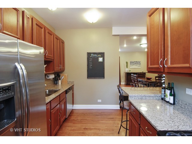 238 Lionel Road Riverside, IL 60546 - Photo 10 of 24 a kitchen with stainless steel appliances granite countertop a sink refrigerator and microwave