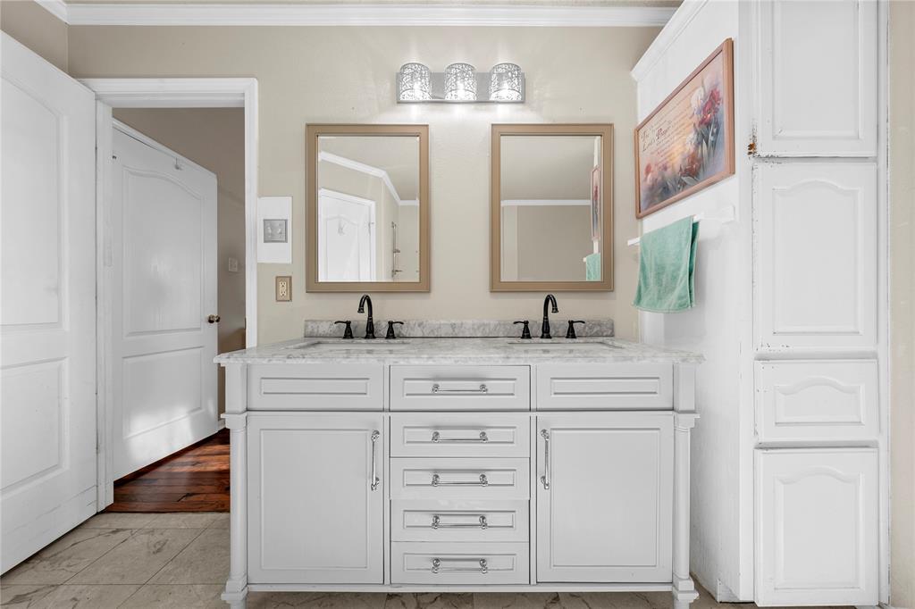 494 Westgate I Road Eddy, TX 76524 - Photo 16 of 34 Full bathroom featuring double vanity, ornamental molding, and light marble finish flooring
