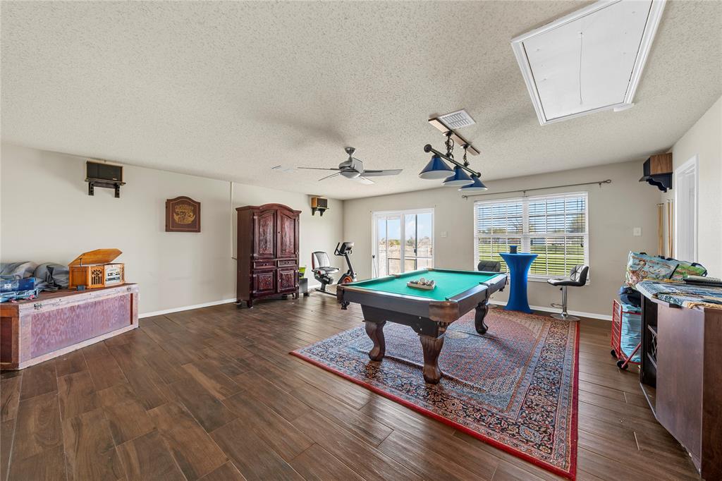 494 Westgate I Road Eddy, TX 76524 - Photo 22 of 34 Rec room featuring pool table, a textured ceiling, dark wood-type flooring, and a ceiling fan