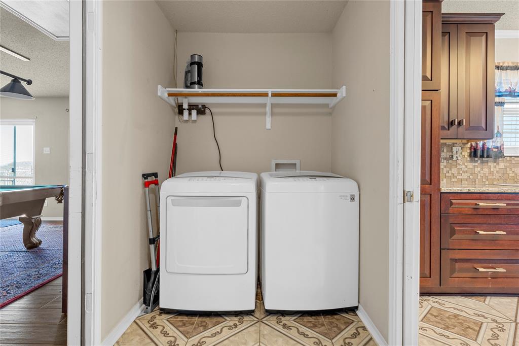 494 Westgate I Road Eddy, TX 76524 - Photo 24 of 34 Laundry room featuring a textured ceiling, pool table, washer and clothes dryer, and light tile patterned flooring