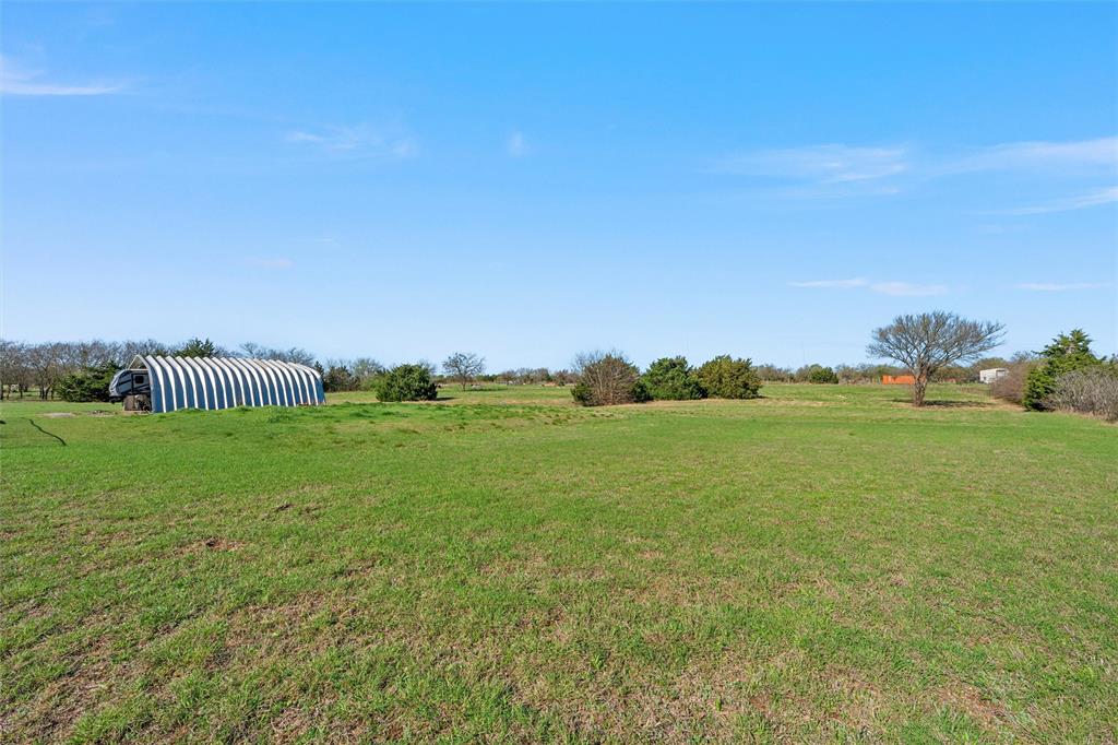 494 Westgate I Road Eddy, TX 76524 - Photo 27 of 34 View of grassy yard featuring a view of countryside and an outbuilding