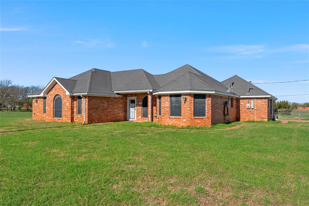 494 Westgate I Road Eddy, TX 76524 - Photo 6 of 34 Ranch-style home featuring brick siding, a front lawn, and a shingled roof