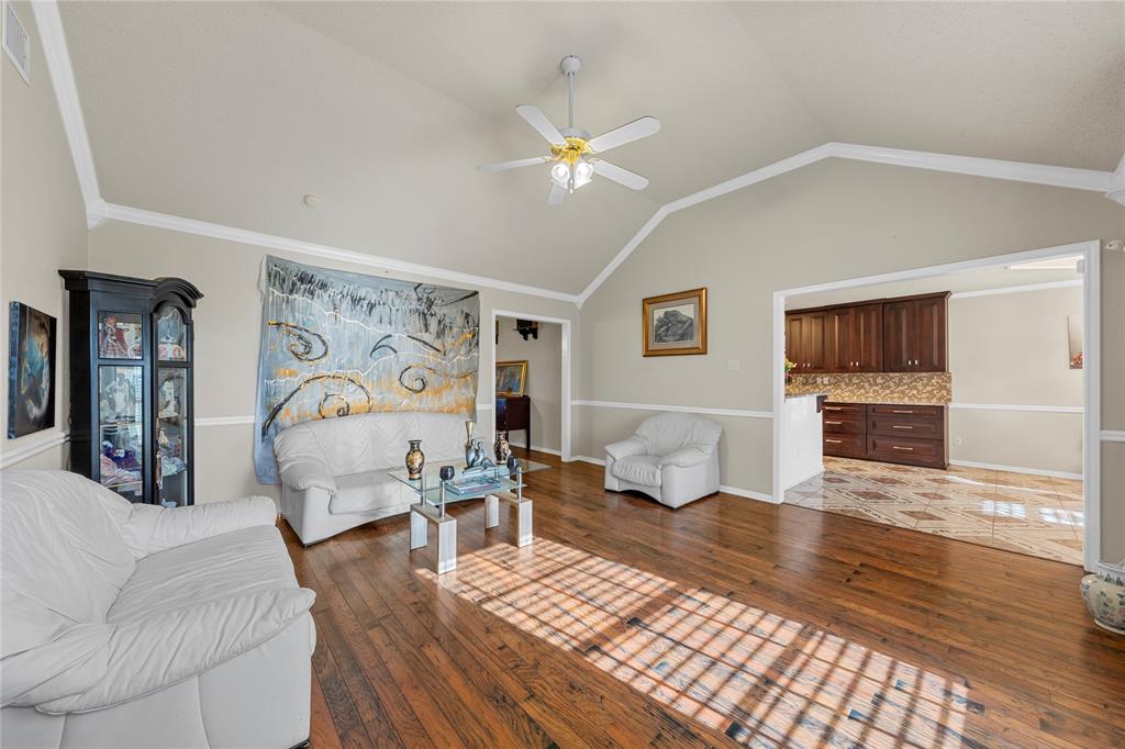 494 Westgate I Road Eddy, TX 76524 - Photo 7 of 34 Living area with dark wood-type flooring, crown molding, and ceiling fan