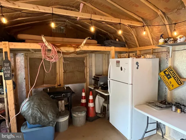 a front view of a house with a garden and tree