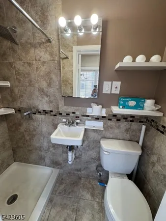 a bathroom with a sink mirror and toilet