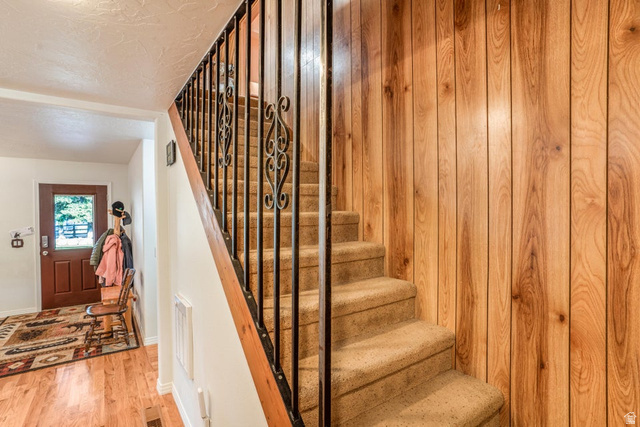48 South Sage Road Pine Valley, UT 84781 - Photo 30 of 61 Carpeted staircase with wrought iron balusters and a wood handrail