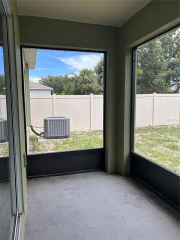 a view of an empty room with a floor to ceiling window