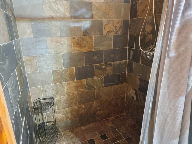 a room with a bed and a television