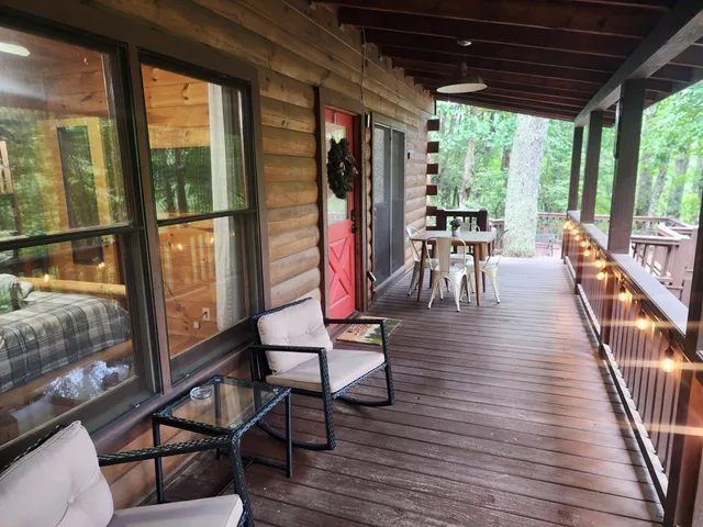 a view of a porch with chairs and wooden floor