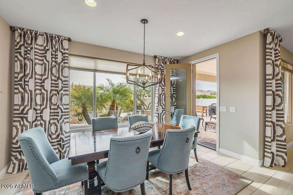 2523 East Nancy Lane Phoenix, AZ 85042 - Photo 11 of 48 a dining room with furniture a chandelier and window