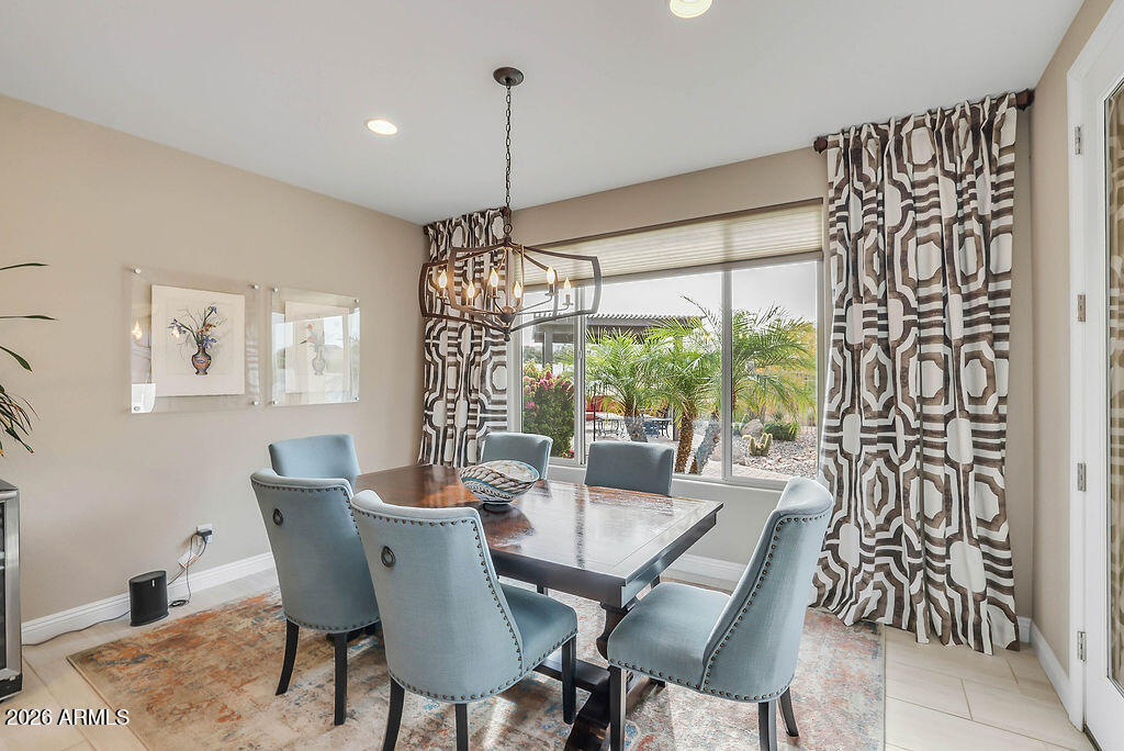 2523 East Nancy Lane Phoenix, AZ 85042 - Photo 13 of 48 a dining room with furniture a chandelier and wooden floor