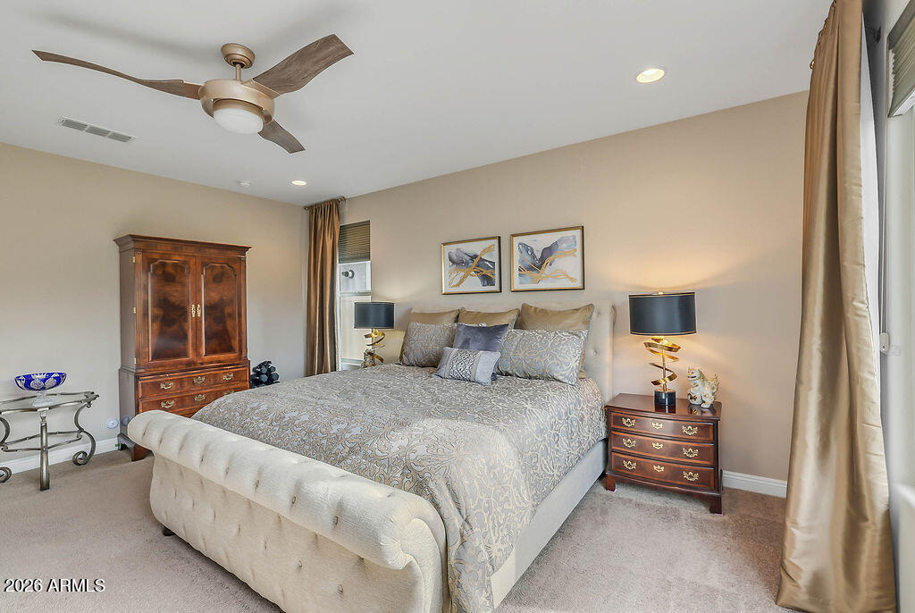 2523 East Nancy Lane Phoenix, AZ 85042 - Photo 18 of 48 a bedroom with a bed and a chandelier