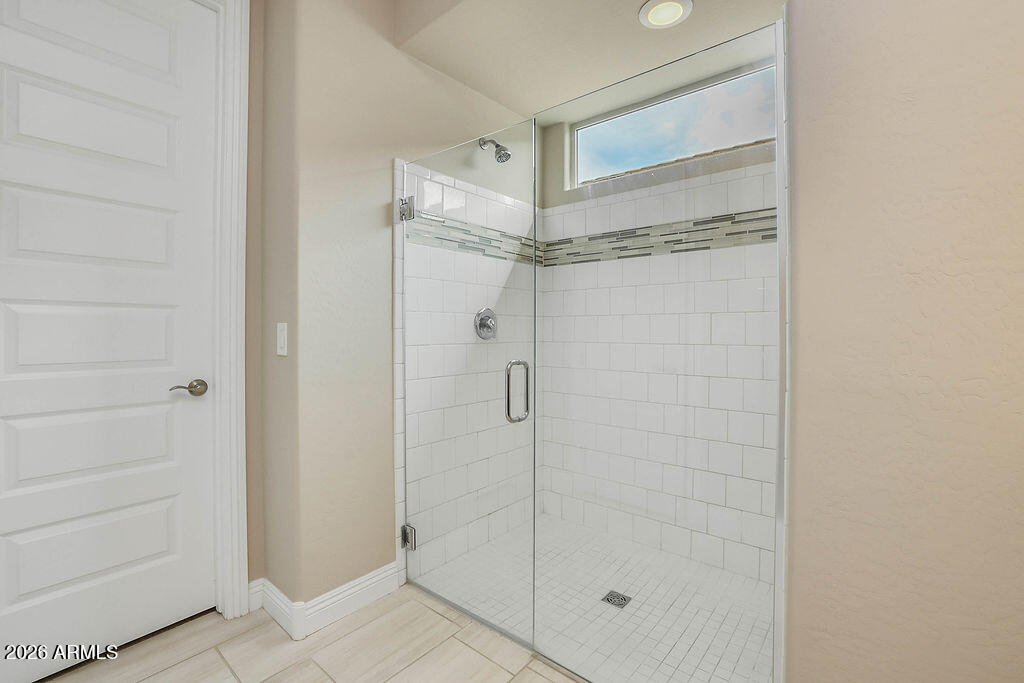 2523 East Nancy Lane Phoenix, AZ 85042 - Photo 20 of 48 a bathroom with a glass shower door