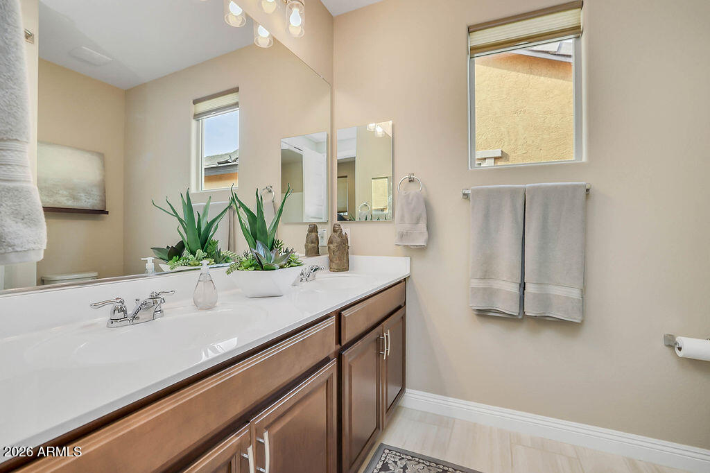 2523 East Nancy Lane Phoenix, AZ 85042 - Photo 24 of 48 a bathroom with a sink and a mirror