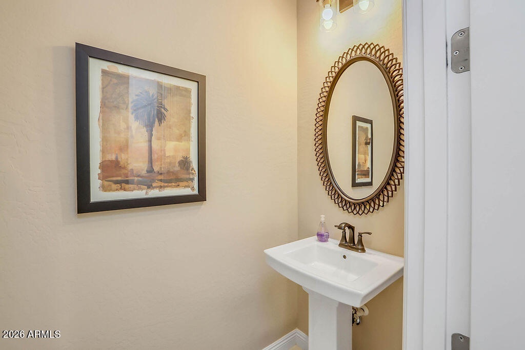 2523 East Nancy Lane Phoenix, AZ 85042 - Photo 26 of 48 a bathroom with a sink and a mirror