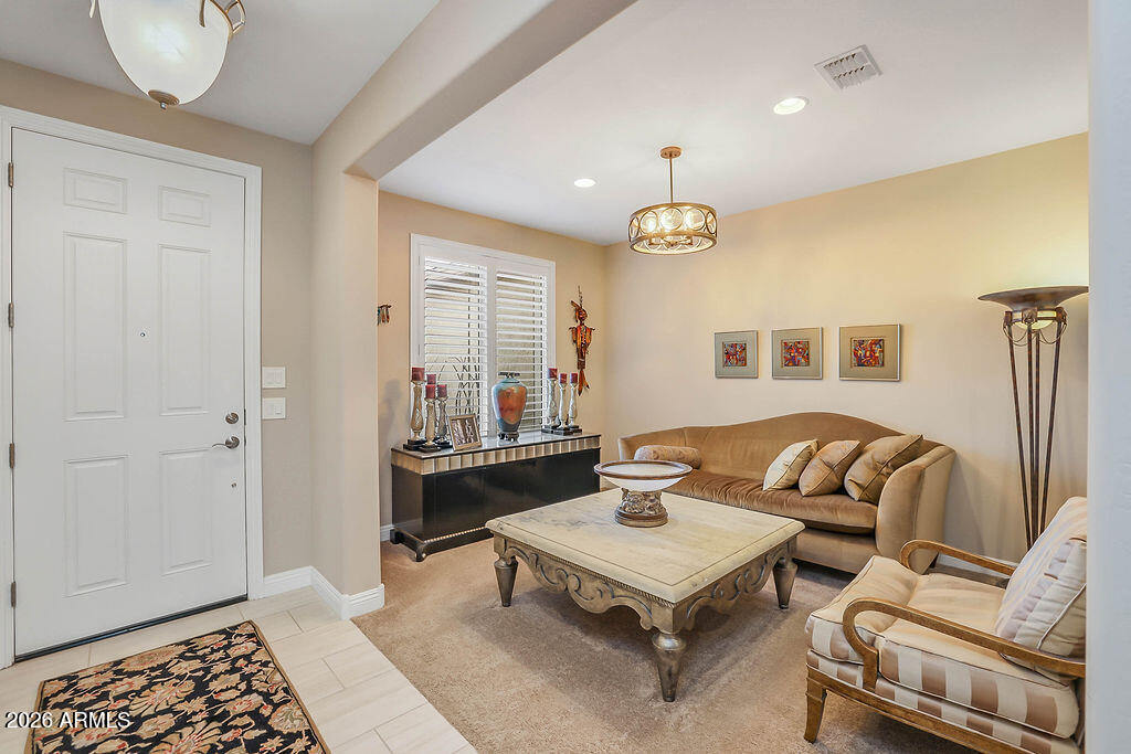 2523 East Nancy Lane Phoenix, AZ 85042 - Photo 5 of 48 a living room with furniture a table and a chandelier