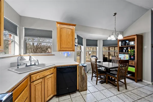 a kitchen that has a table chairs in it and wooden floors