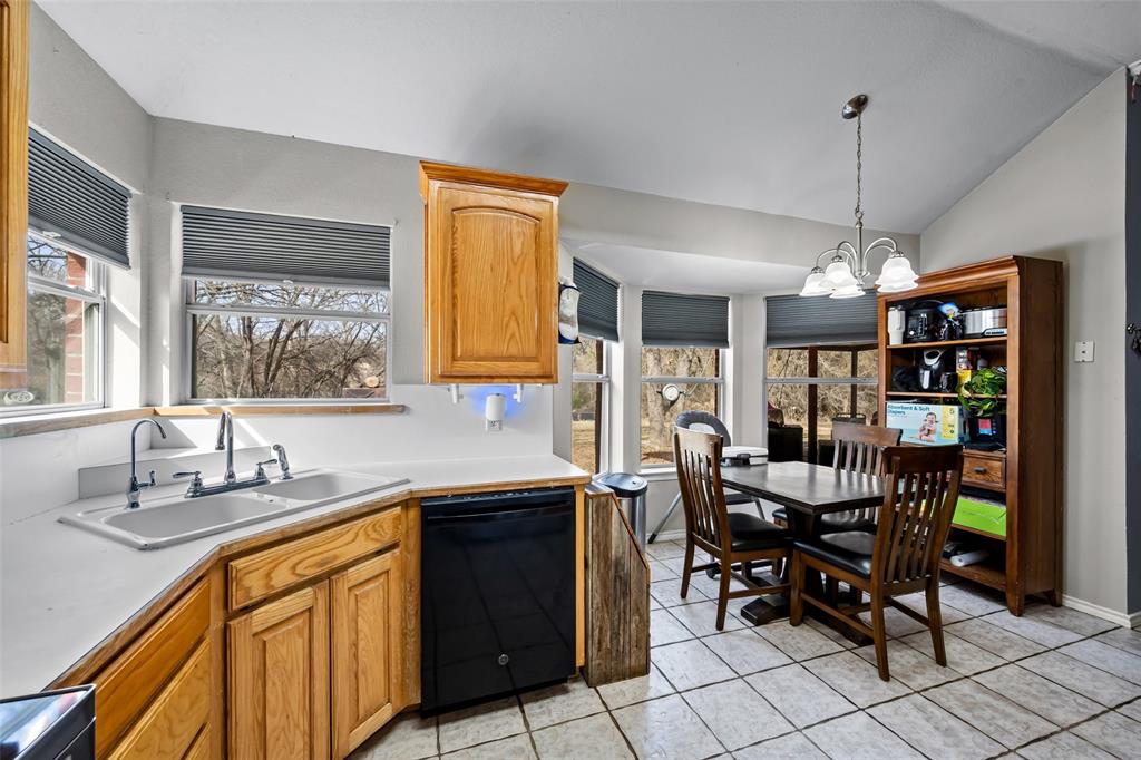 7698 Farm To Market 920 Poolville, TX 76487 - Photo 11 of 37 a kitchen that has a table chairs in it and wooden floors