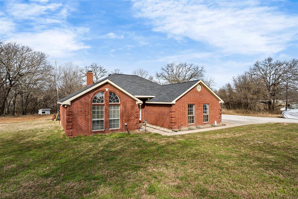 7698 Farm To Market 920 Poolville, TX 76487 - Photo 2 of 37 a view of a house with a yard