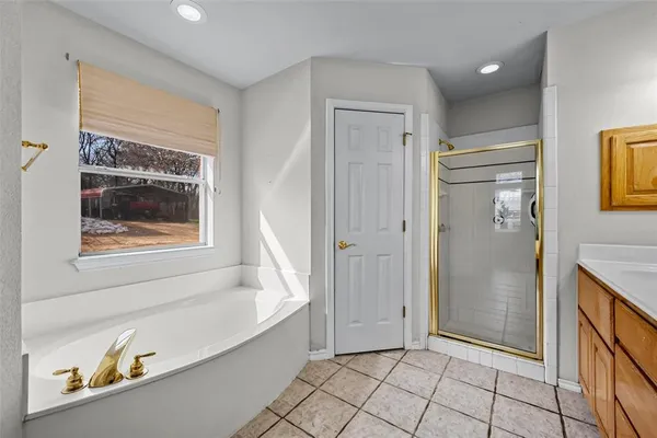 a bathroom with a bathtub and shower