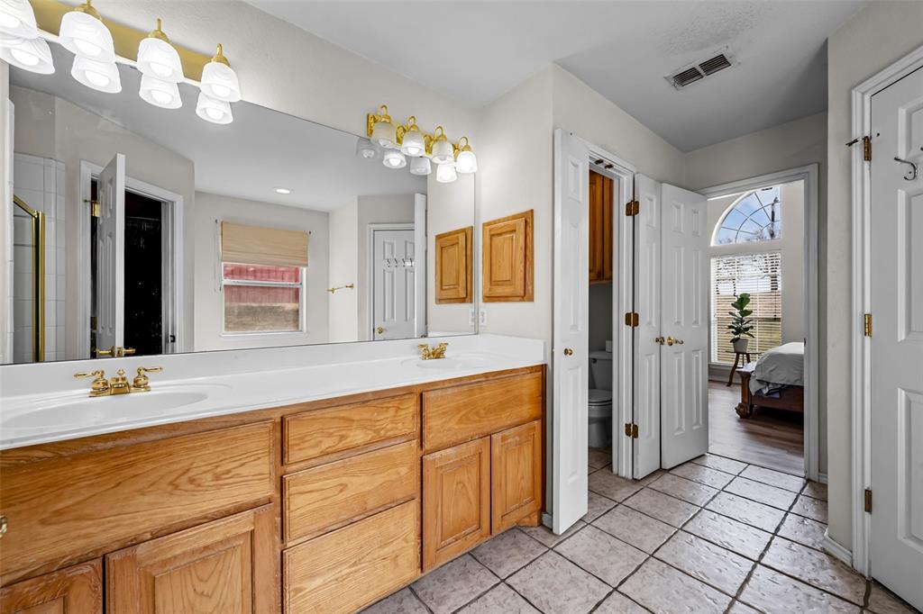 7698 Farm To Market 920 Poolville, TX 76487 - Photo 23 of 37 a spacious bathroom with a shower a sink and a mirror
