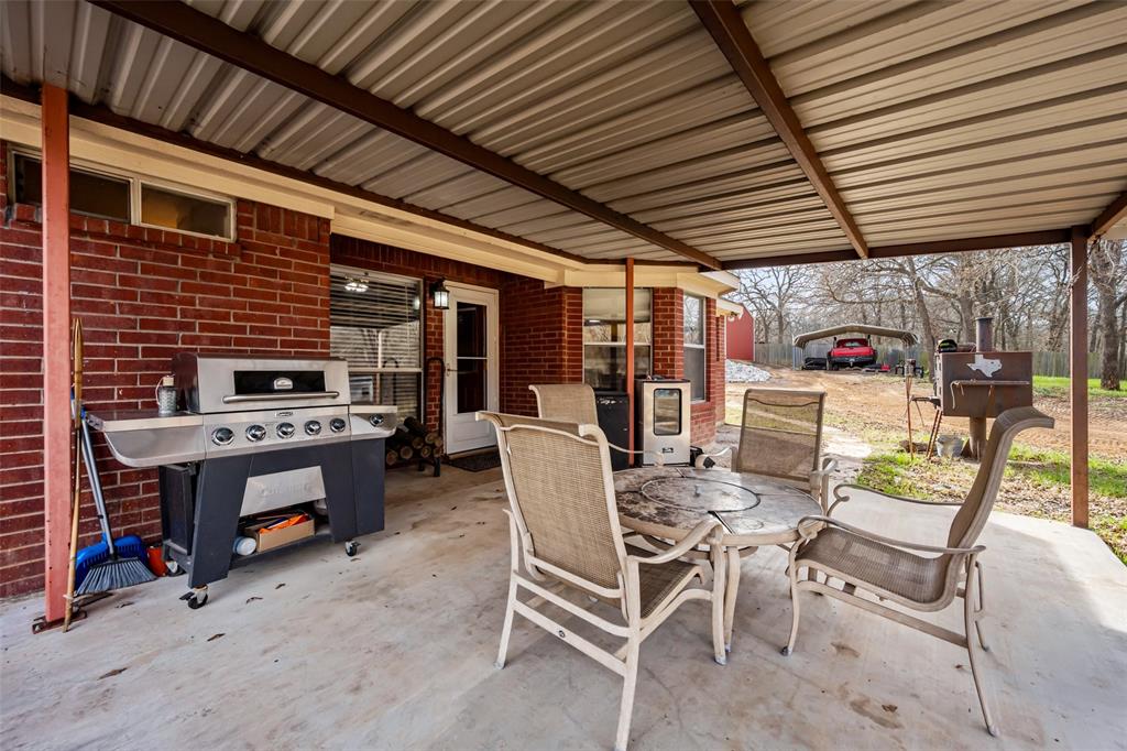 7698 Farm To Market 920 Poolville, TX 76487 - Photo 25 of 37 a patio with a table and chairs