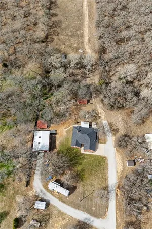 an aerial view of a house with a yard