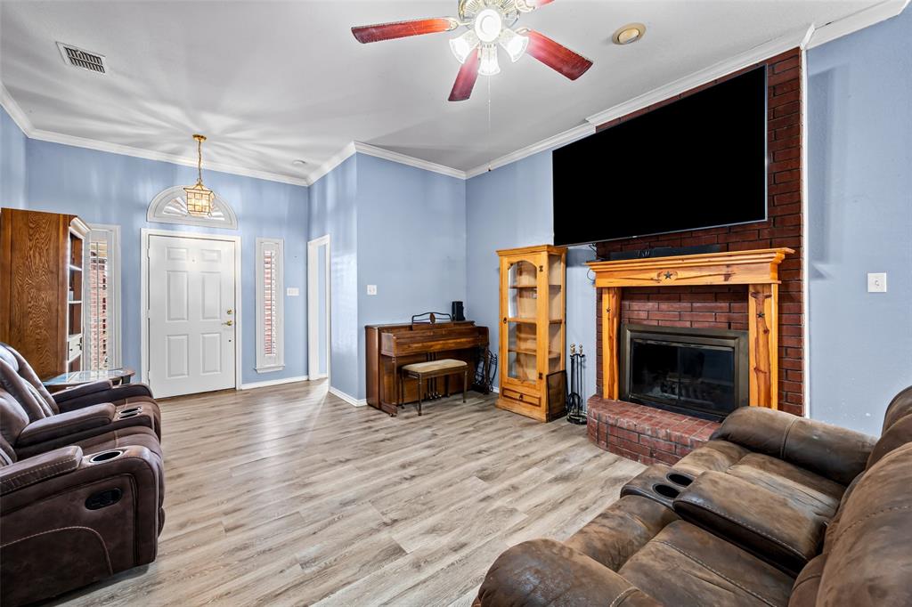 7698 Farm To Market 920 Poolville, TX 76487 - Photo 5 of 37 a living room with furniture and a flat screen tv