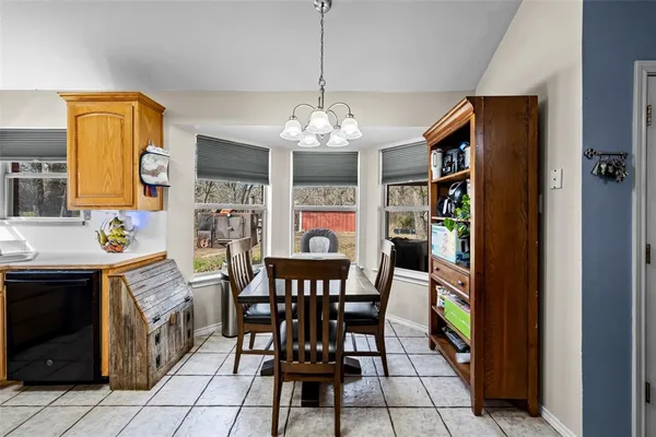 a view of a dining room with furniture and window