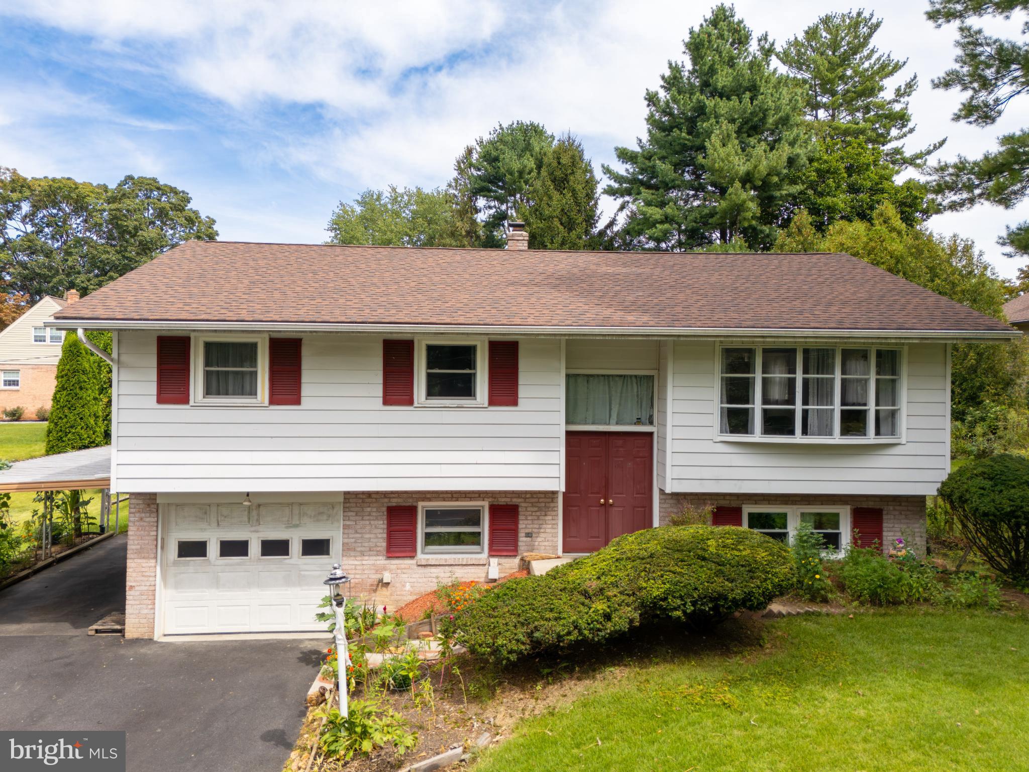 105 School House Road Lancaster, PA 17603 - Photo 1 of 33 Charming split-level home with lush greenery.