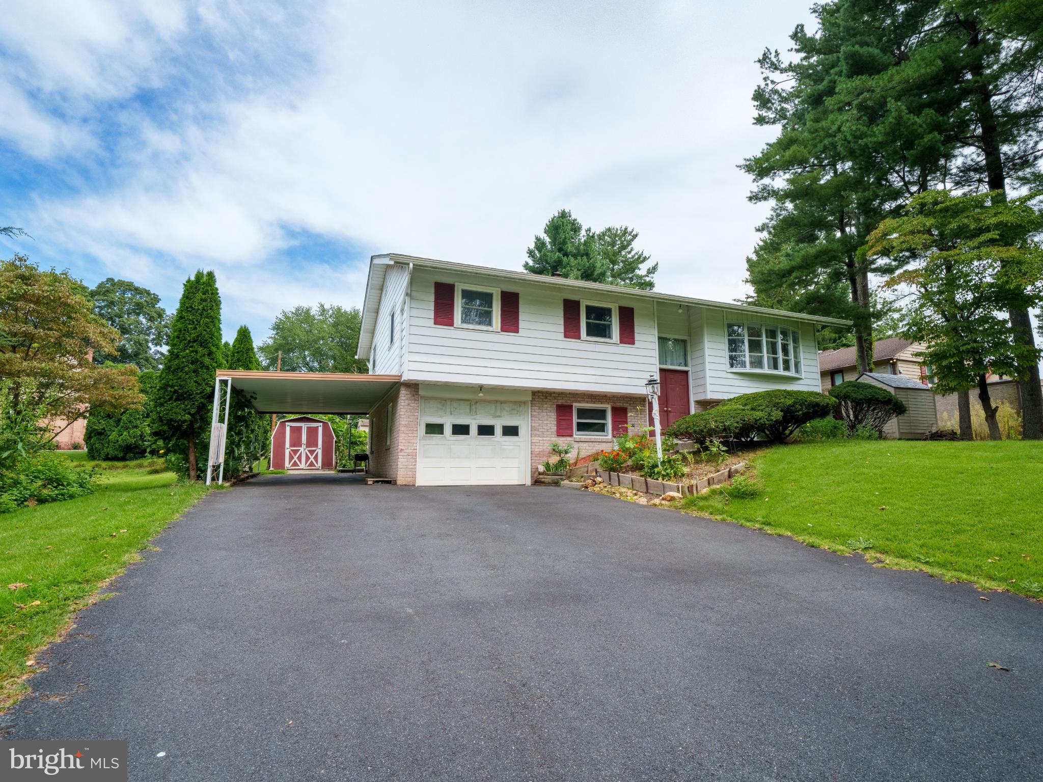 105 School House Road Lancaster, PA 17603 - Photo 2 of 33 Charming split-level home with lush greenery.