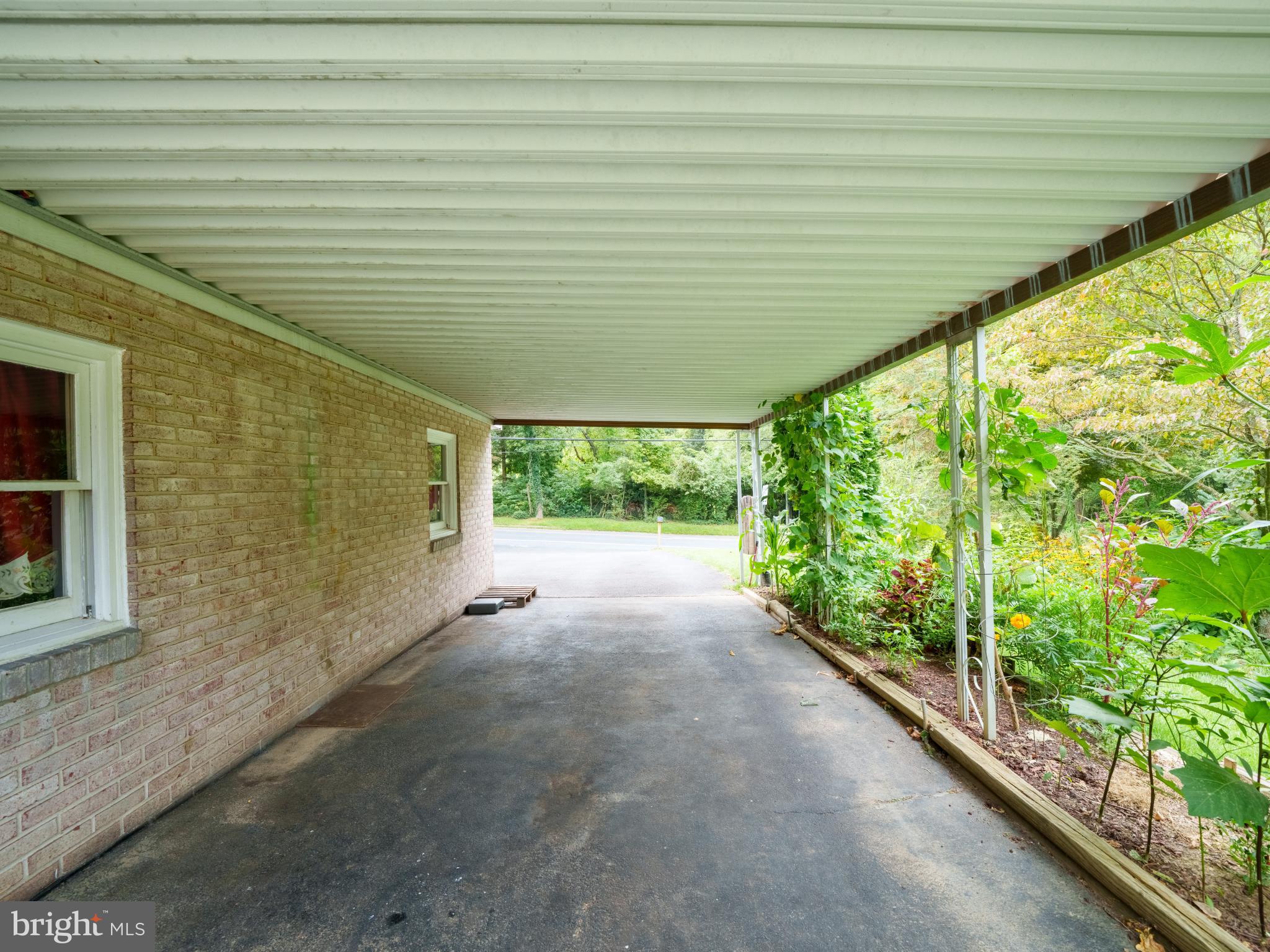 105 School House Road Lancaster, PA 17603 - Photo 26 of 33 Charming carport with lush garden views.