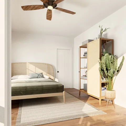 a bedroom with a bed and a potted plant