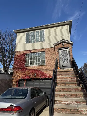a front view of a house with parking space