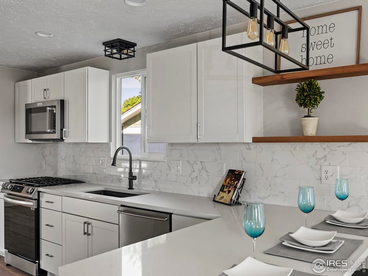 829 Independence Drive Longmont, CO 80504 - Photo 11 of 31 Quartz countertops and new tile backsplash in the kitchen