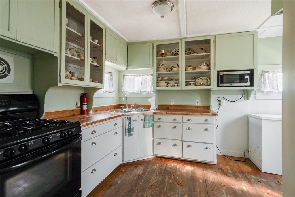 1255 Old Plainville Road New Bedford, MA 02745 - Photo 15 of 23 a kitchen with stainless steel appliances a stove sink and cabinets