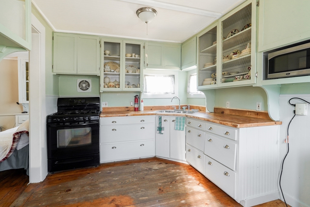 1255 Old Plainville Road New Bedford, MA 02745 - Photo 5 of 23 a kitchen with stainless steel appliances a stove and a refrigerator