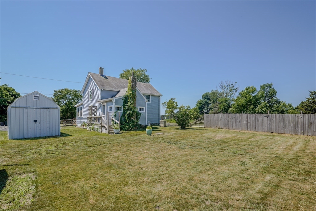 1255 Old Plainville Road New Bedford, MA 02745 - Photo 8 of 23 a front view of a house with a yard and garage