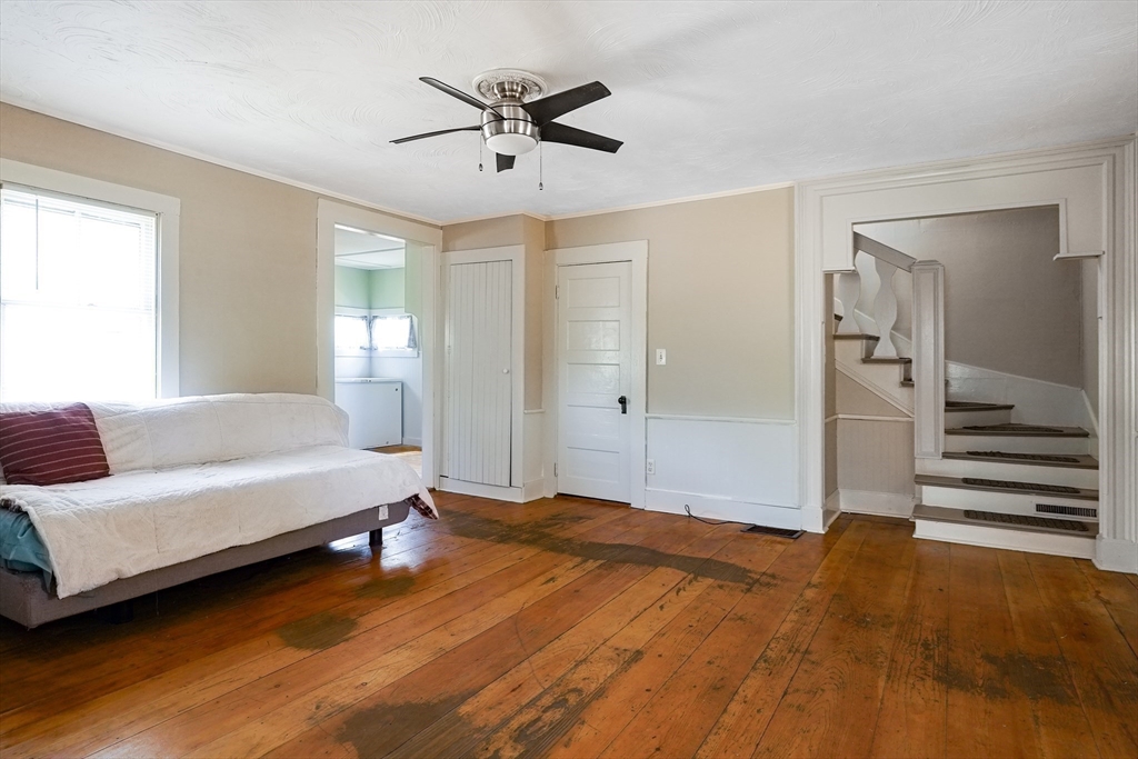 1255 Old Plainville Road New Bedford, MA 02745 - Photo 10 of 23 a spacious bedroom with a bed and a chandelier