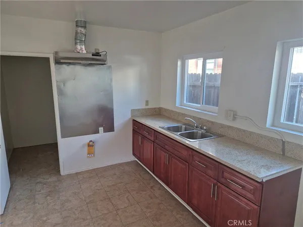 a kitchen with a refrigerator and a sink