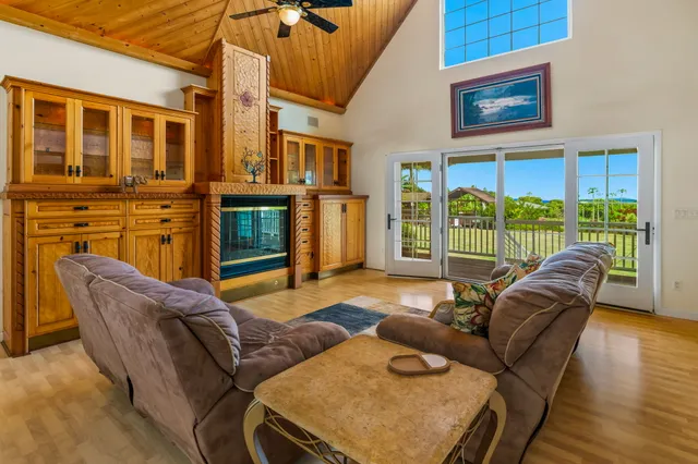 a living room with furniture a fireplace and wooden floor