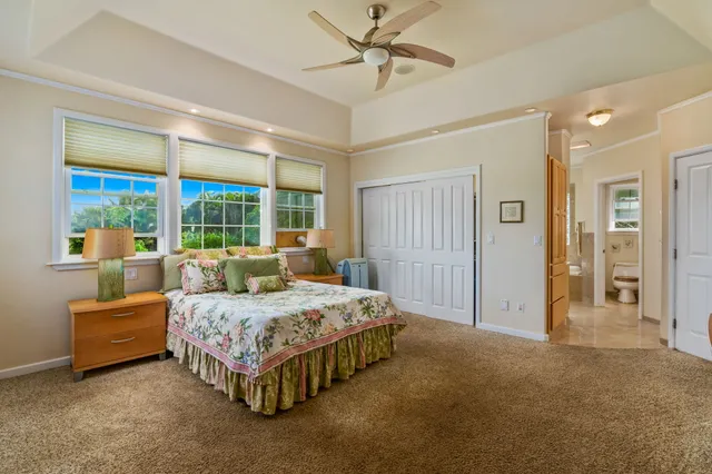 a bedroom with a bed and large window