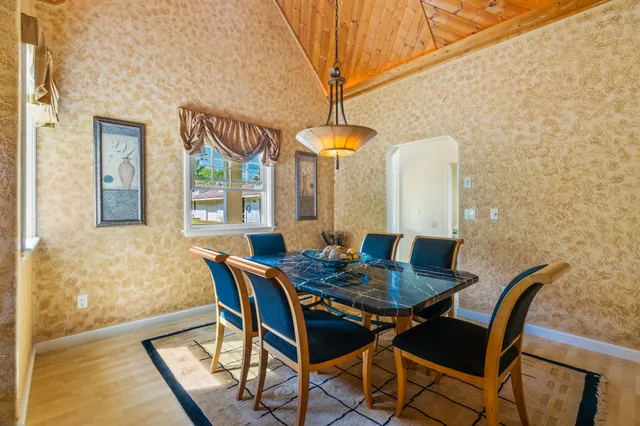 a view of a dining room with furniture and window