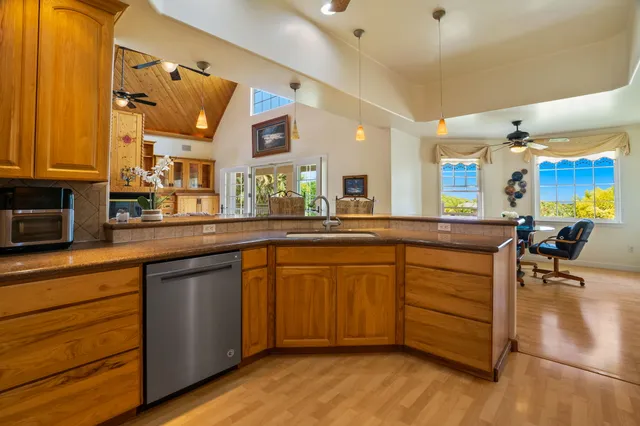 a kitchen with stainless steel appliances granite countertop a sink and cabinets