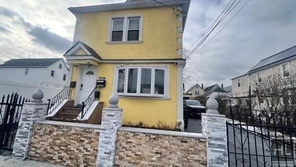 a front view of a house with many windows