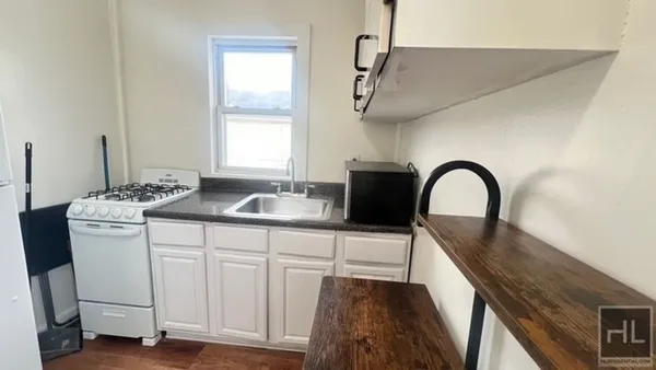 a kitchen with a sink a counter space and cabinets