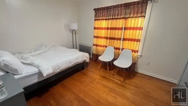 a bed room with a bed chair and a window